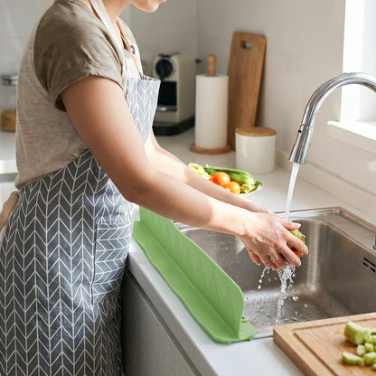 Splash guard in use washing vegetables